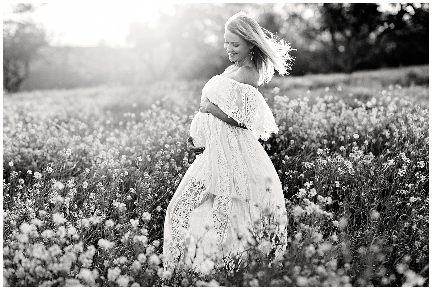 Black and white backlit pregnant woman in field of flowers in Harrisonburg, VA