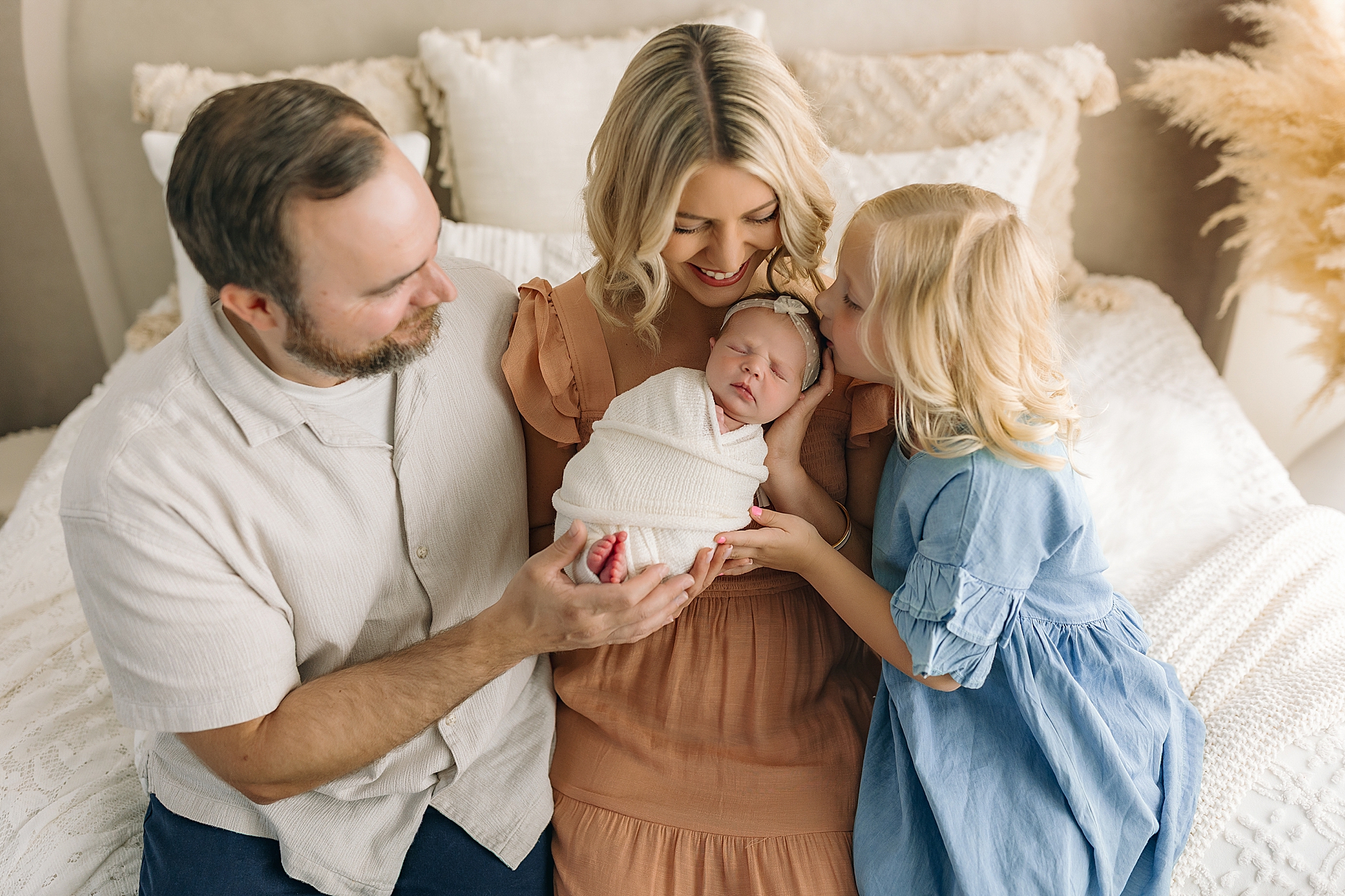 Family holding newborn baby girl in Harrisonburg photography studio