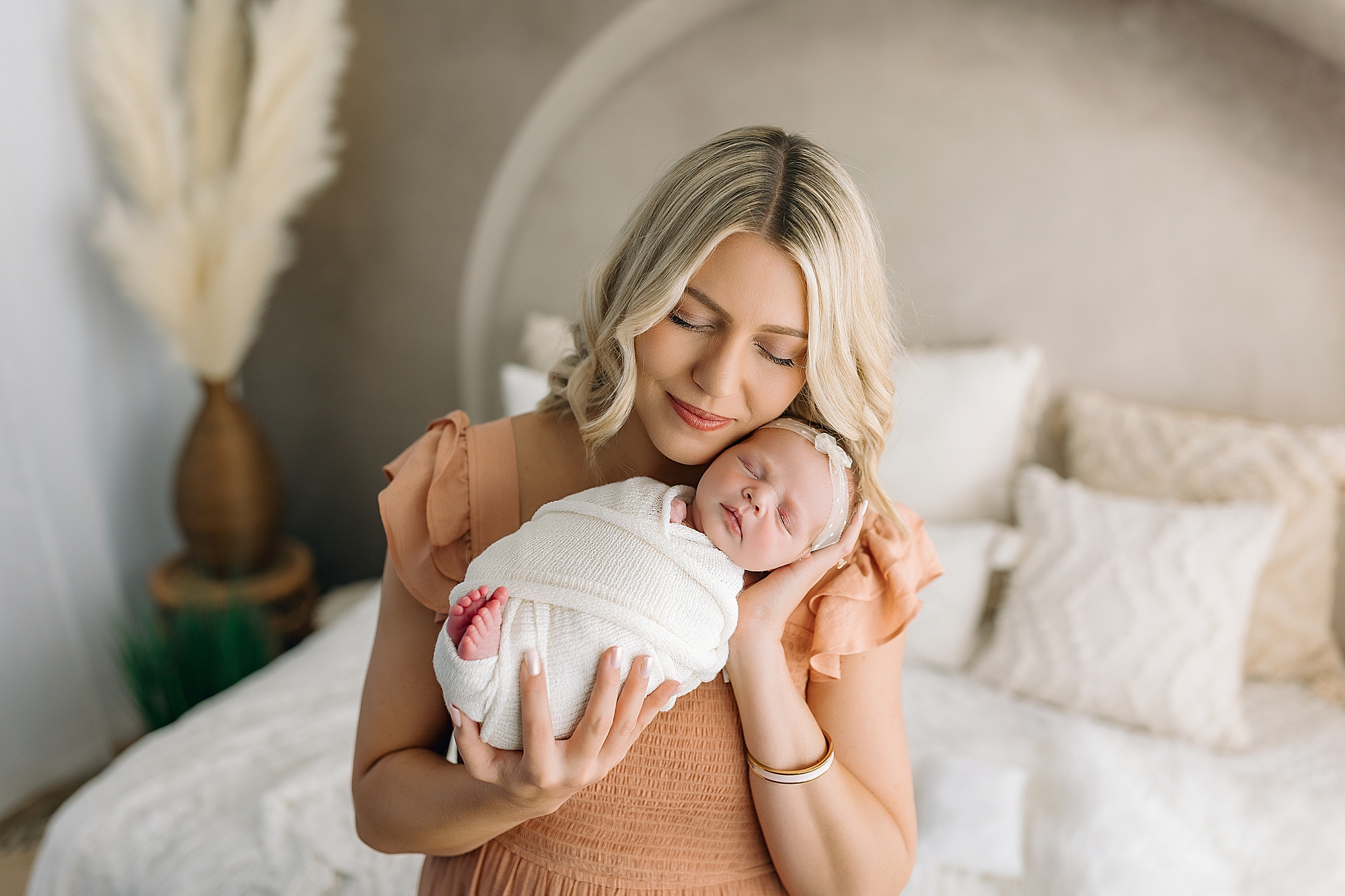 Mom snuggling with newborn baby in Harrisonburg VA newborn studio